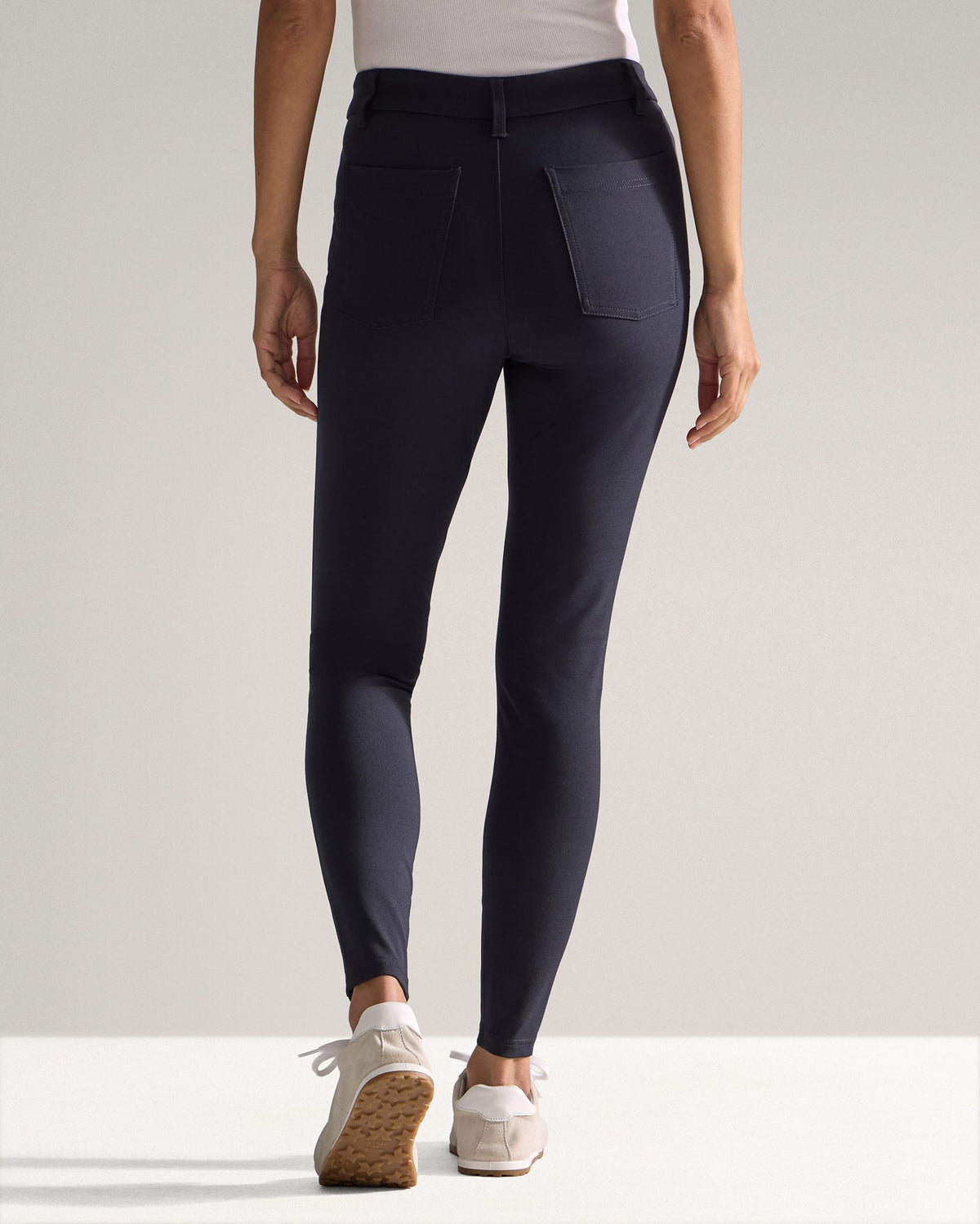 Navy | Woman walking in the Women's Everyday Pant, lower body front view with sneakers