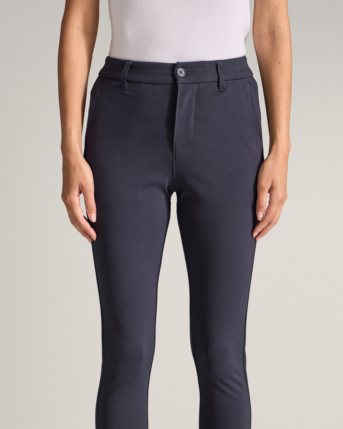 Navy | Close-up front view of the Women's Everyday Pant waistband and fit, hands at sides