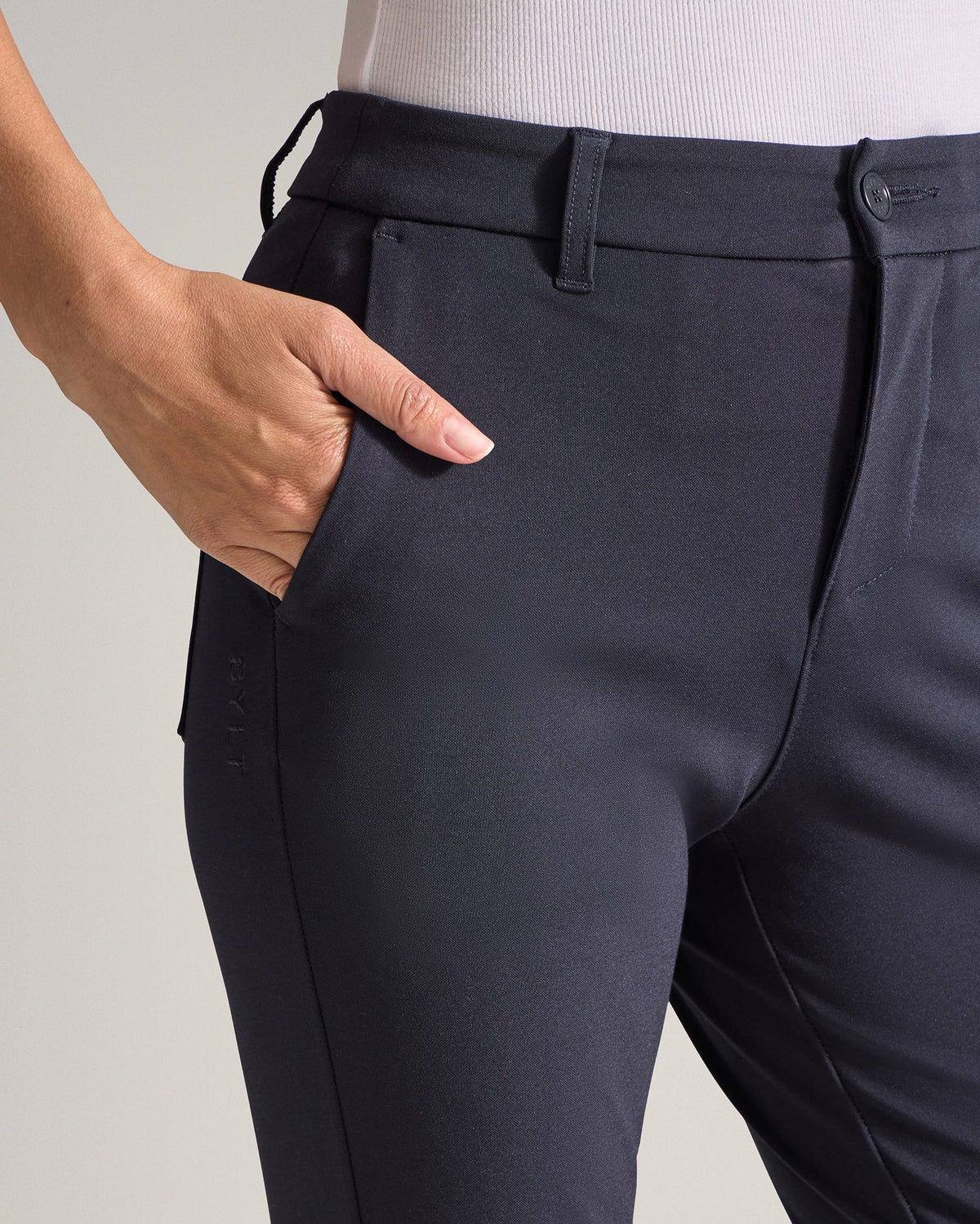 Navy | Close-up of the Women's Everyday Pant side pocket with hand in pocket